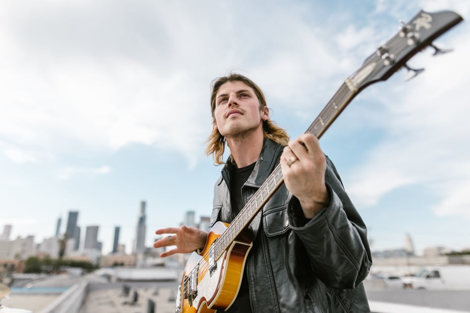 Man in Black Leather Jacket playing an Electric Guitar 